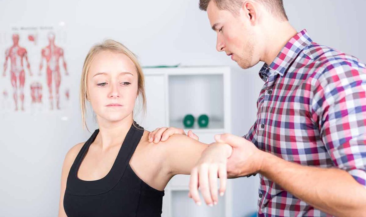 Physical therapist doing Manual Therapy on a female patient's shoulder