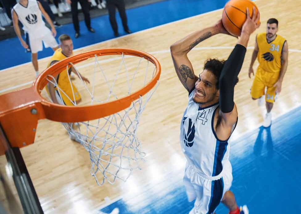 basketball player in midair jumping to make a shot