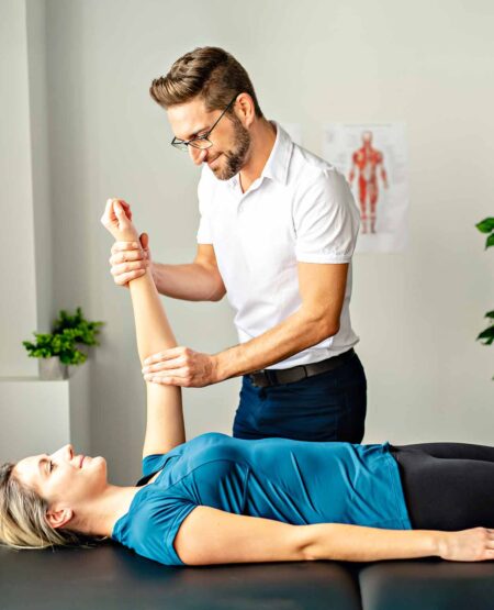 A male physical therapist treats a female's patient using script free (direct access) to check her elbow pain condition.