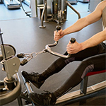 man doing shoulder resistance exercises with cable pulley